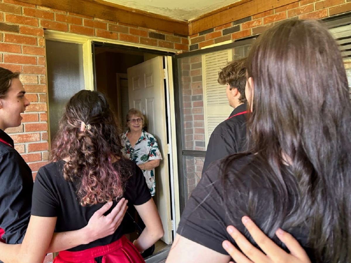 Members of LGHS's chorus deliver a singing telegram to Carmela Colandrea at her home for Valentine's Day.