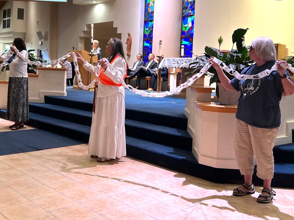 Members of the Polk Ecumenical Action Council for Empowerment held up a paper chain of signatures from people who want to see a pre-arrest diversion program used more frequently so people with non-violent traffic cases don't wind up with a criminal record.